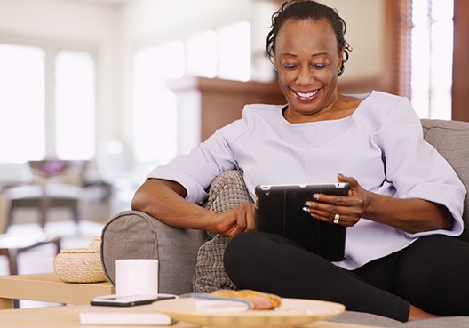 A woman goes online to look for suitable products to help her invest for retirement.