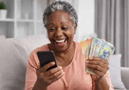 A woman holding a phone and cash