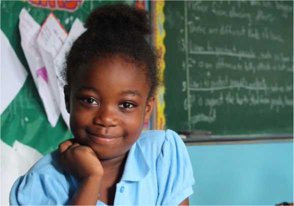 A schoolgirl smiles in a photo taken at her school.
