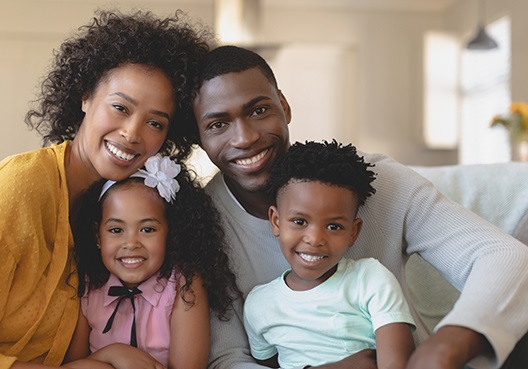 A Ghanaian couple with two children enjoy spending time together at their home.